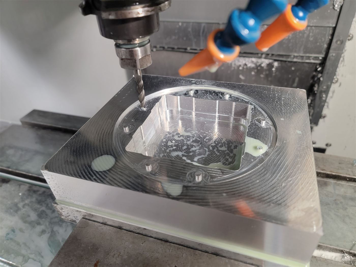 CNC mill machining a part with coolant