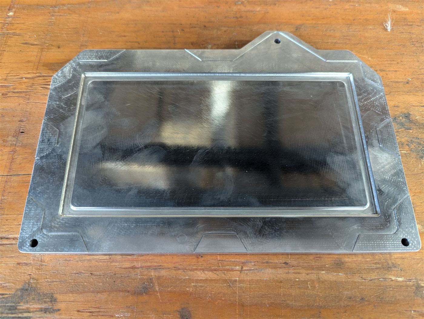Machined aluminum panel with a window cutout