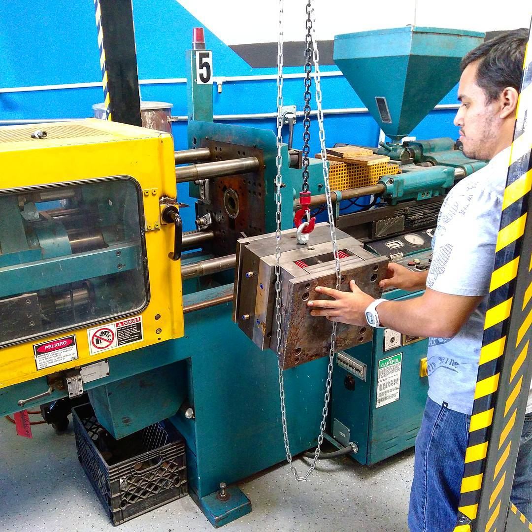 Tera technician loading a mold into an injection molding machine